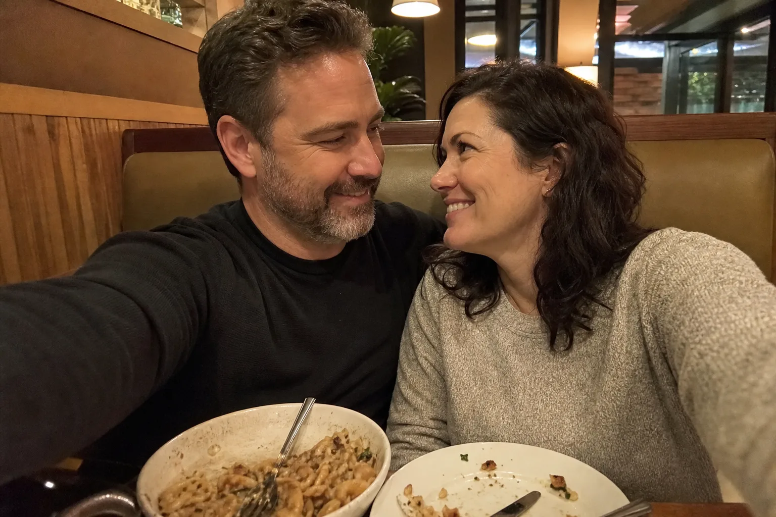 A married couple takes a selfie together on a simple date night.
