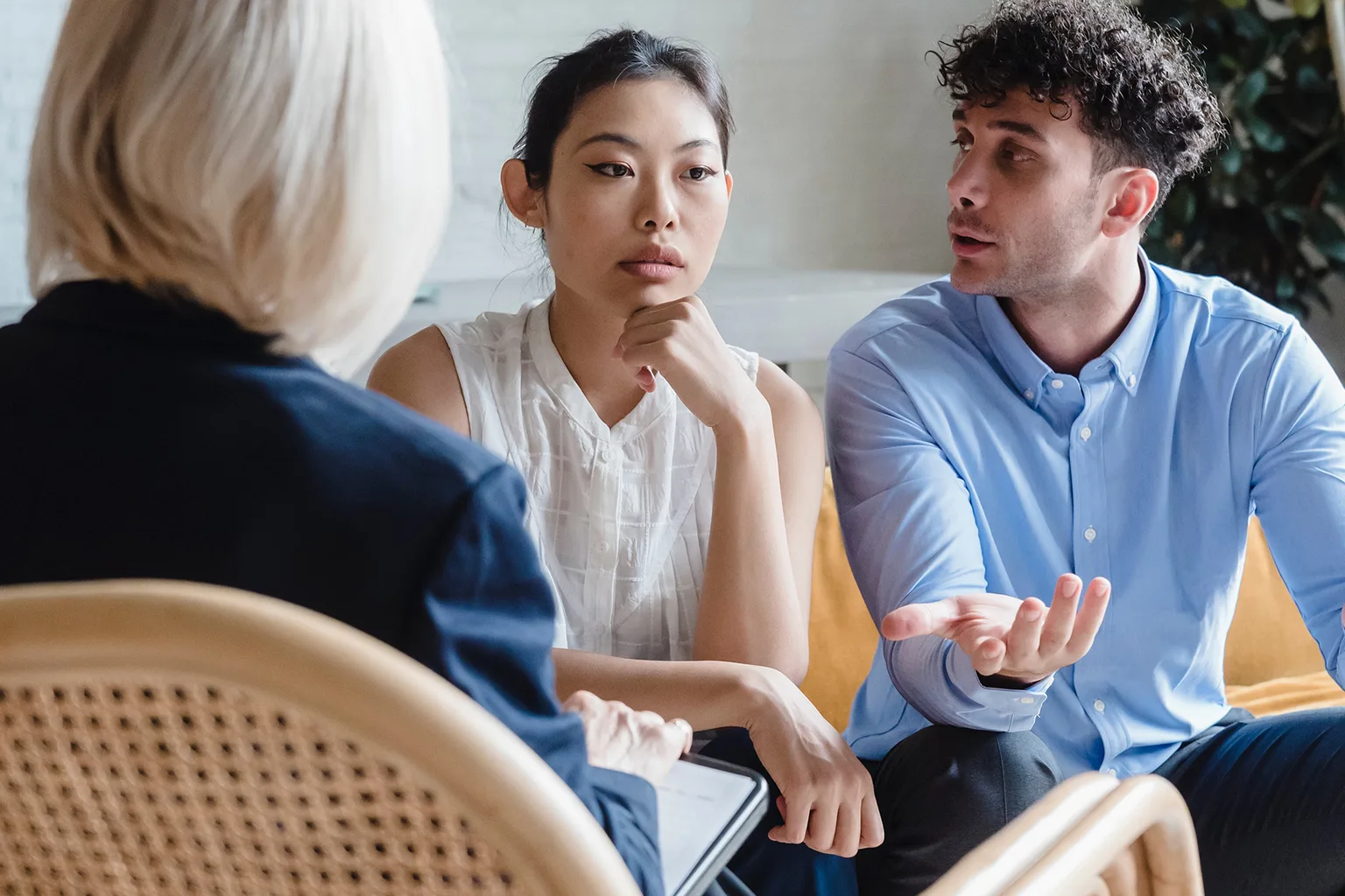 A couple speaks with a relationship professional during a session.