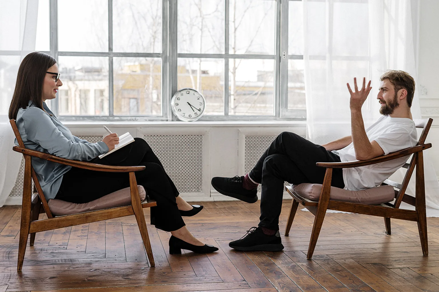 A client talks with a professional in a bright, private office.